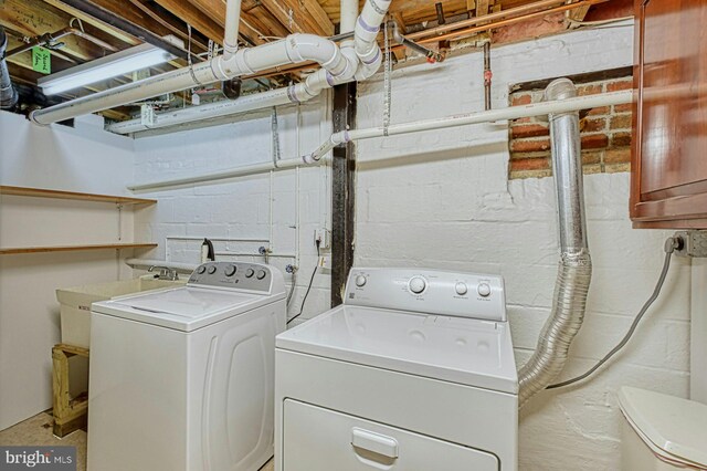 3820 Lorcom Ln, Arlington, VA 22207 - laundry area featuring washer and clothes dryer and concrete block wall