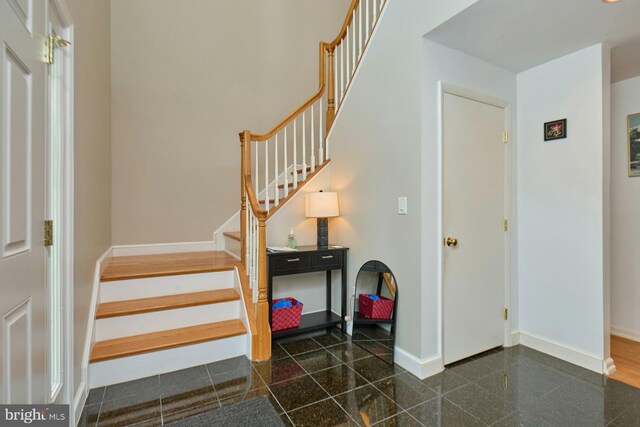 3820 Lorcom Ln, Arlington, VA 22207 - foyer entrance featuring granite floors, baseboards, and stairs