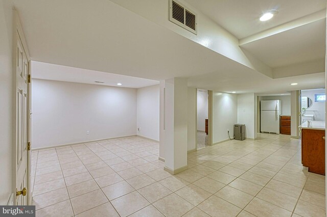 3820 Lorcom Ln, Arlington, VA 22207 - finished below grade area featuring freestanding refrigerator, recessed lighting, light tile patterned floors, and baseboards