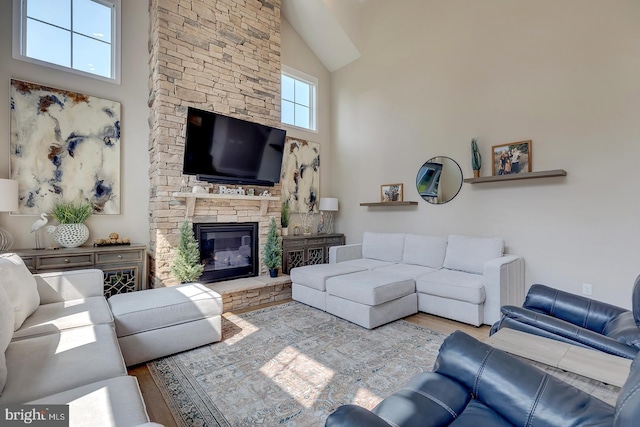 33610 Union Cir, Lewes, DE 19958 - living room with high vaulted ceiling, wood finished floors, and a stone fireplace