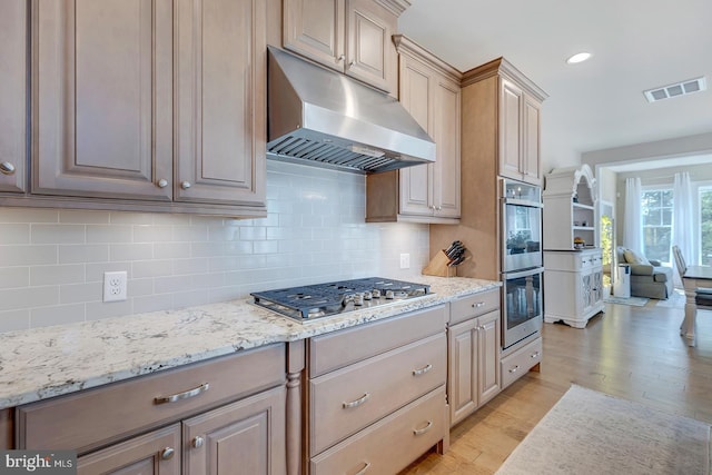 33610 Union Cir, Lewes, DE 19958 - kitchen featuring under cabinet range hood, stainless steel appliances, light wood-type flooring, tasteful backsplash, and recessed lighting