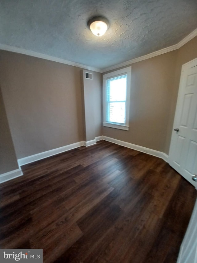 513 N Highland Ave, Baltimore, MD 21205 - empty room featuring crown molding, dark wood finished floors, baseboards, and a textured ceiling