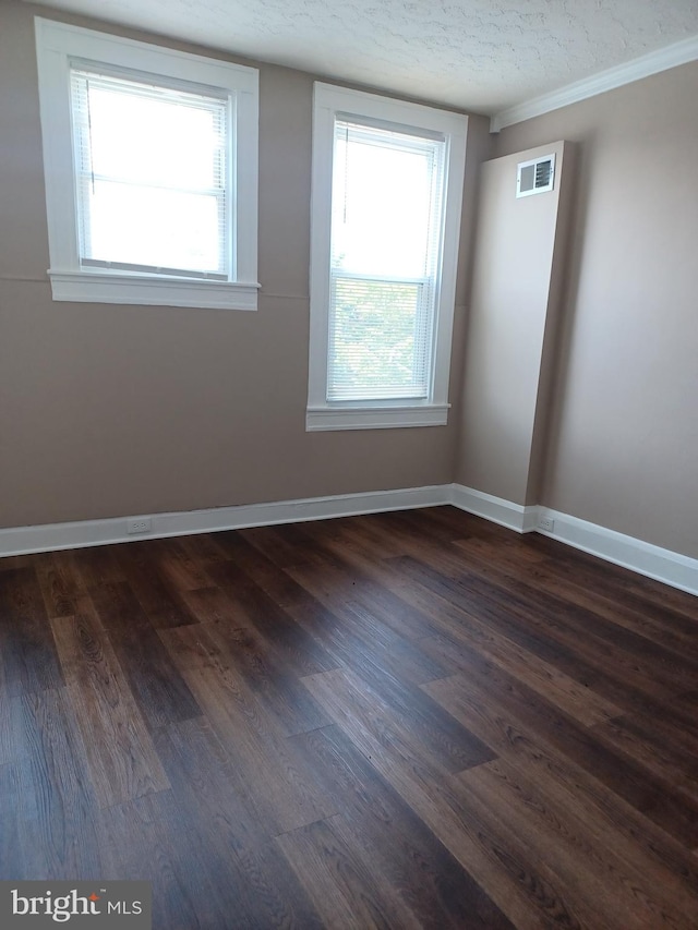 513 N Highland Ave, Baltimore, MD 21205 - spare room featuring dark wood finished floors, baseboards, a textured ceiling, and crown molding
