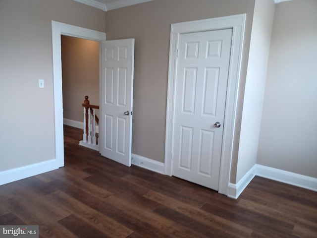 513 N Highland Ave, Baltimore, MD 21205 - unfurnished bedroom featuring dark wood-style floors, baseboards, and crown molding