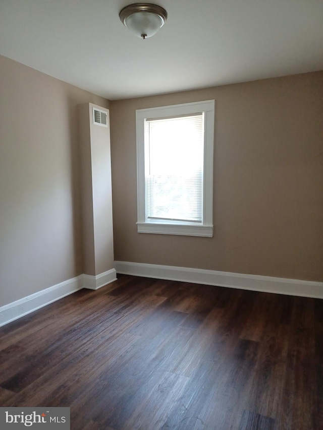 513 N Highland Ave, Baltimore, MD 21205 - spare room with dark wood finished floors and baseboards