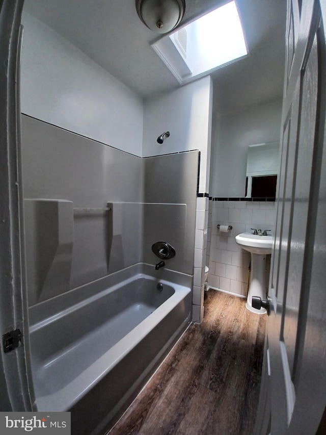 513 N Highland Ave, Baltimore, MD 21205 - full bath with tile walls, wood finished floors, shower / bath combination, a sink, and toilet