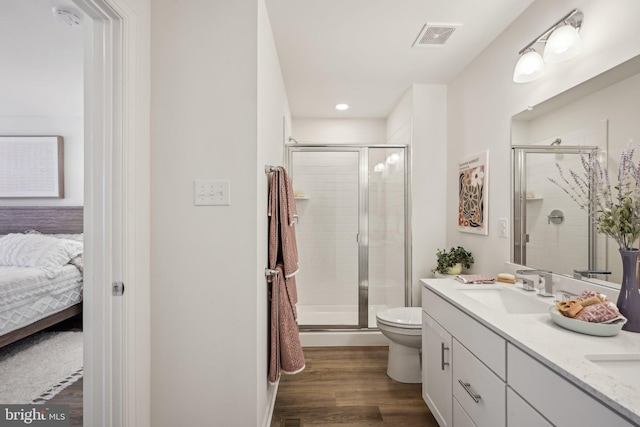 1807 Arch St Unit 21E, Norristown, PA 19401 - ensuite bathroom with double vanity, toilet, a shower stall, wood finished floors, and recessed lighting