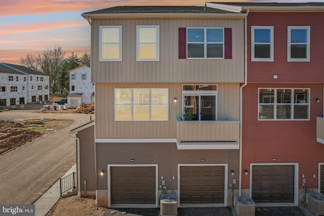 1807 Arch St Unit 21E, Norristown, PA 19401 - view of front of property featuring a garage, central AC unit, and driveway