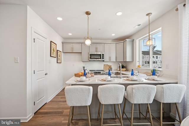 1807 Arch St Unit 21E, Norristown, PA 19401 - kitchen with stainless steel appliances, a peninsula, gray cabinets, baseboards, and recessed lighting