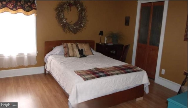 1620 Florence St, Williamsport, PA 17701 - bedroom featuring multiple windows, wood finished floors, and baseboards
