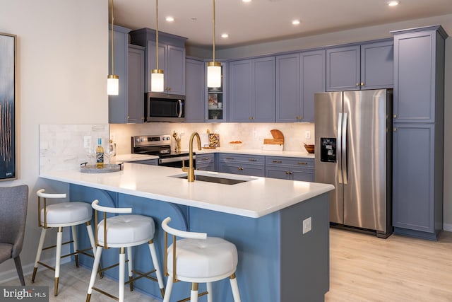 9981A Justify Run, Laurel, MD 20723 - kitchen with stainless steel appliances, a peninsula, a kitchen breakfast bar, tasteful backsplash, and recessed lighting