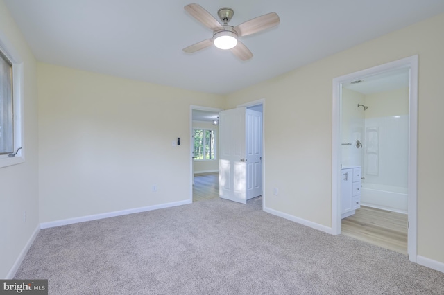 9708 Martinsburg Rd, Hedgesville, WV 25427 - unfurnished bedroom featuring light carpet, baseboards, ensuite bathroom, and a ceiling fan
