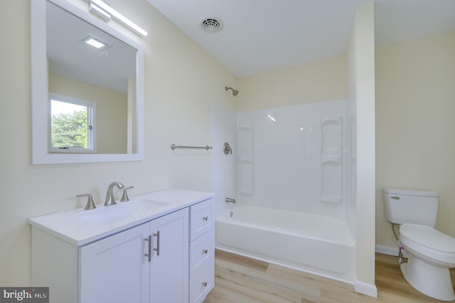 9708 Martinsburg Rd, Hedgesville, WV 25427 - full bath with wood finished floors, toilet, vanity, and shower / bath combination
