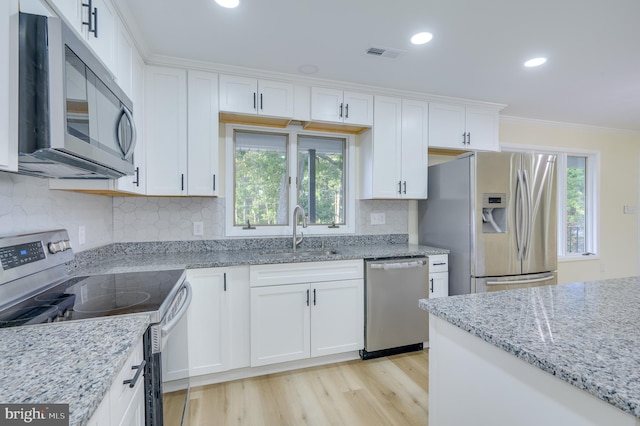 9708 Martinsburg Rd, Hedgesville, WV 25427 - kitchen with stainless steel appliances, a sink, ornamental molding, plenty of natural light, and white cabinetry