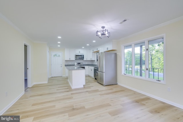 9708 Martinsburg Rd, Hedgesville, WV 25427 - kitchen featuring appliances with stainless steel finishes, ornamental molding, white cabinets, baseboards, and light wood-style flooring