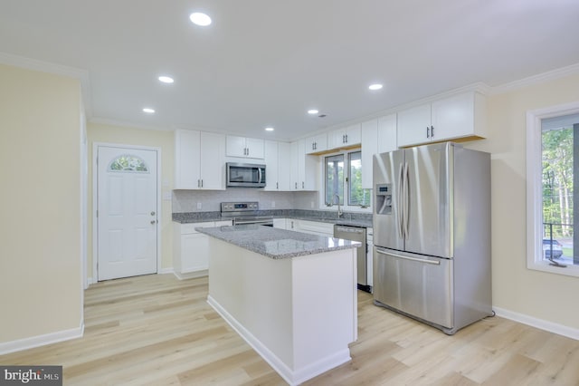 9708 Martinsburg Rd, Hedgesville, WV 25427 - kitchen with stainless steel appliances, crown molding, plenty of natural light, a center island, and white cabinetry