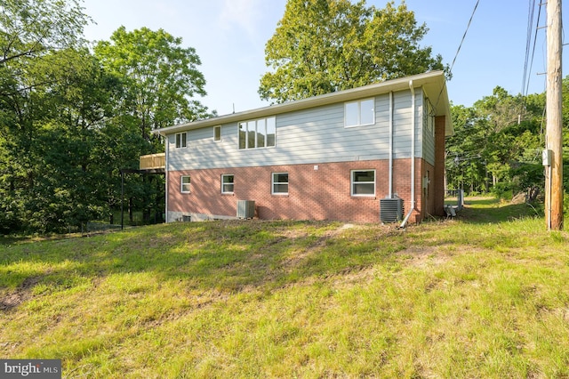 9708 Martinsburg Rd, Hedgesville, WV 25427 - back of property featuring cooling unit, brick siding, and a lawn