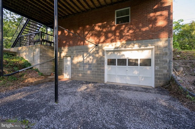 9708 Martinsburg Rd, Hedgesville, WV 25427 - view of side of home featuring stairs, brick siding, an attached garage, and gravel driveway