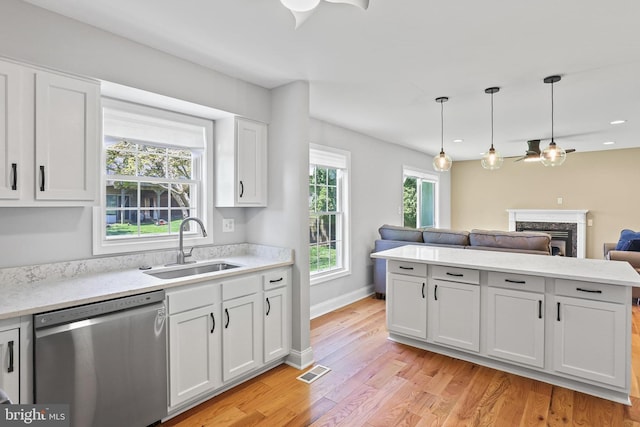 9416 Seven Courts Dr, Baltimore, MD 21236 - kitchen featuring stainless steel dishwasher, a sink, a fireplace, open floor plan, and ceiling fan