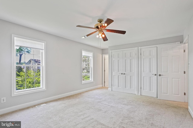9416 Seven Courts Dr, Baltimore, MD 21236 - unfurnished bedroom featuring multiple closets, baseboards, and carpet floors