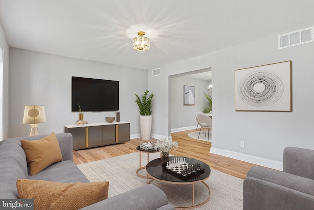 9416 Seven Courts Dr, Baltimore, MD 21236 - living area featuring a chandelier, light wood-style floors, and baseboards