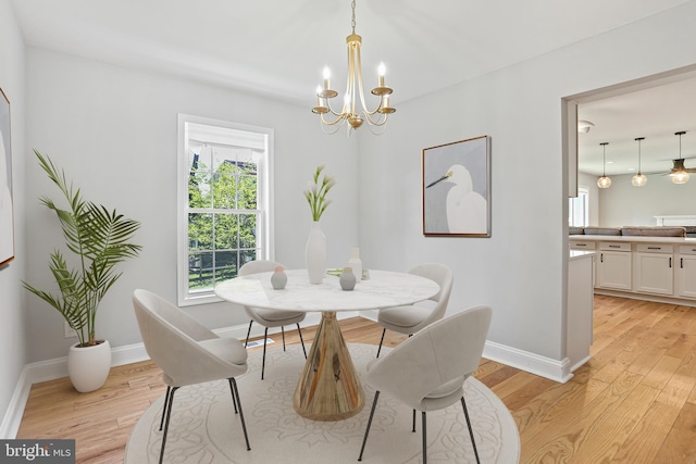 9416 Seven Courts Dr, Baltimore, MD 21236 - dining area featuring a chandelier, light wood-type flooring, and baseboards