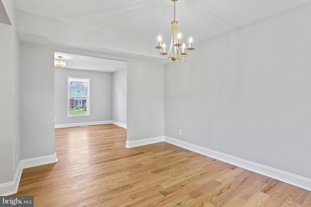 9416 Seven Courts Dr, Baltimore, MD 21236 - spare room with a chandelier, light wood-style floors, and baseboards