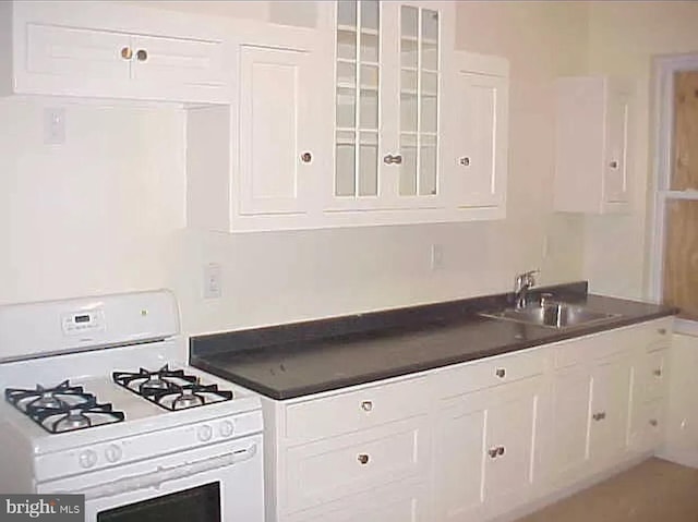 420 N Glover St, Baltimore, MD 21224 - kitchen with white gas range, white cabinets, and dark countertops