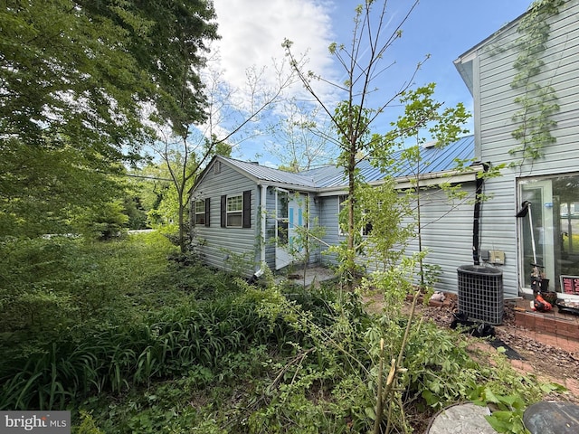 42264 Ridge Rd, Mechanicsville, MD 20659 - view of home's exterior featuring central AC, metal roof, and a standing seam roof