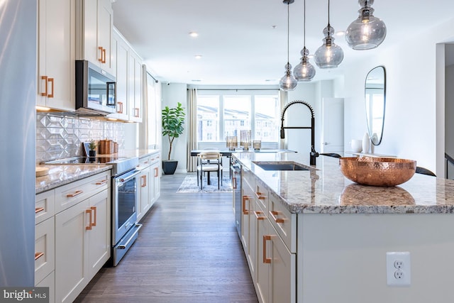 10009B American Pharoah Ln, Laurel, MD 20723 - kitchen with stainless steel appliances, a sink, wood finished floors, tasteful backsplash, and a center island with sink