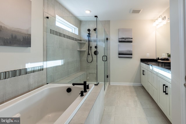 10009B American Pharoah Ln, Laurel, MD 20723 - full bath with vanity, a shower stall, a bath, tile patterned floors, and baseboards