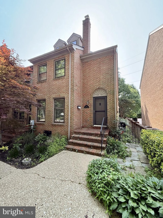 912 N Bancroft Pkwy, Wilmington, DE 19805 - property entrance with brick siding and a chimney