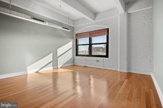 1100 S Broad St Unit 404C & # 212P, Philadelphia, PA 19146 - unfurnished living room featuring wood finished floors and beam ceiling