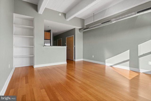 1100 S Broad St Unit 404C & # 212P, Philadelphia, PA 19146 - unfurnished living room with wood finished floors and beamed ceiling