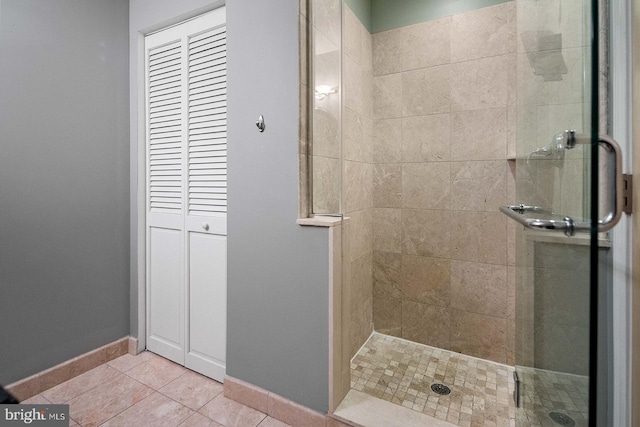 1100 S Broad St Unit 404C & # 212P, Philadelphia, PA 19146 - full bath featuring a shower stall, tile patterned floors, and a closet