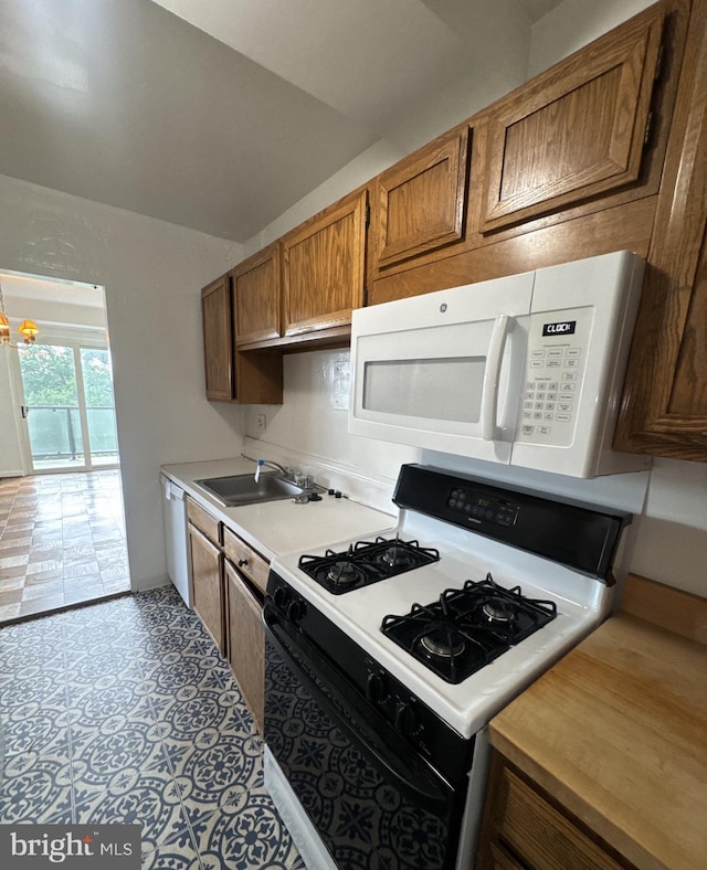 4201 Cathedral Ave NW Unit 1209W, Washington, DC 20016 - kitchen featuring range with gas stovetop, white microwave, dishwashing machine, light countertops, and brown cabinets
