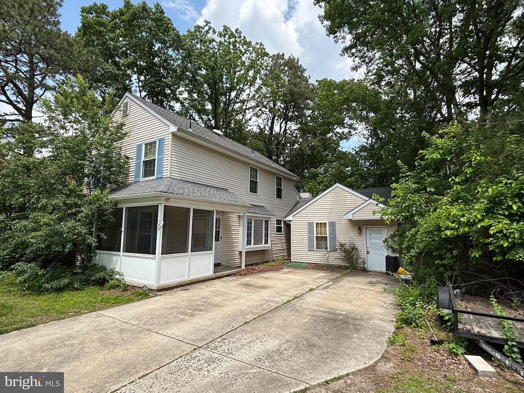 125 Ebbetts Dr, Atco, NJ 08004 - view of front of home featuring a sunroom, concrete driveway, and roof with shingles