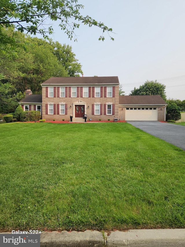 6103 Gallery St, Bowie, MD 20720 - view of front of home featuring brick siding, driveway, a front yard, and a garage