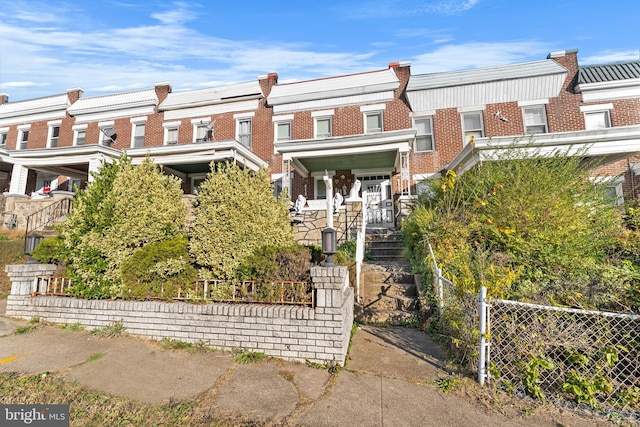 2808 Presstman St, Baltimore, MD 21216 - view of property with brick siding, stairway, and covered porch