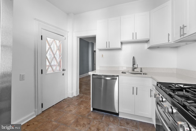 2808 Presstman St, Baltimore, MD 21216 - kitchen featuring stainless steel appliances, a sink, white cabinets, and light countertops