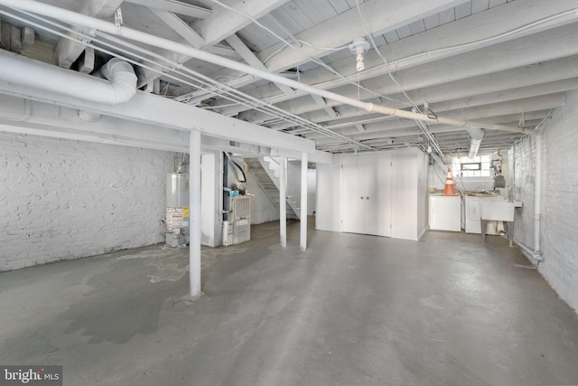2808 Presstman St, Baltimore, MD 21216 - below grade area with water heater, stairway, heating unit, and washing machine and clothes dryer
