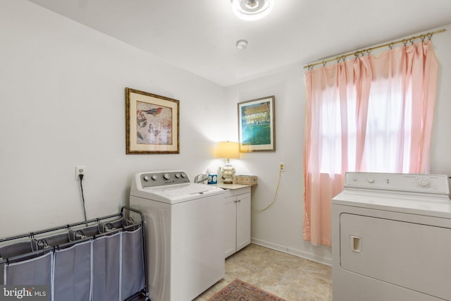 206 Mountain Rd, Linthicum Heights, MD 21090 - laundry room with washing machine and clothes dryer, baseboards, and cabinet space