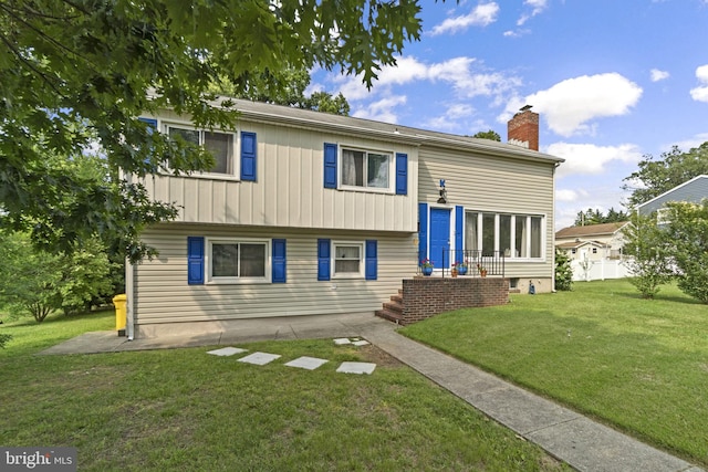 206 Mountain Rd, Linthicum Heights, MD 21090 - back of property with a yard, a chimney, and board and batten siding
