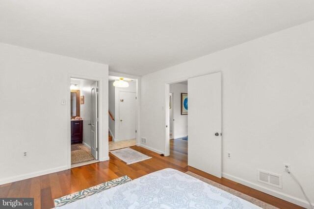 206 Mountain Rd, Linthicum Heights, MD 21090 - unfurnished bedroom with wood finished floors, baseboards, and ensuite bath