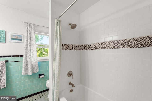 206 Mountain Rd, Linthicum Heights, MD 21090 - bathroom with shower / bath combination with curtain, toilet, tile walls, tile patterned floors, and a wainscoted wall