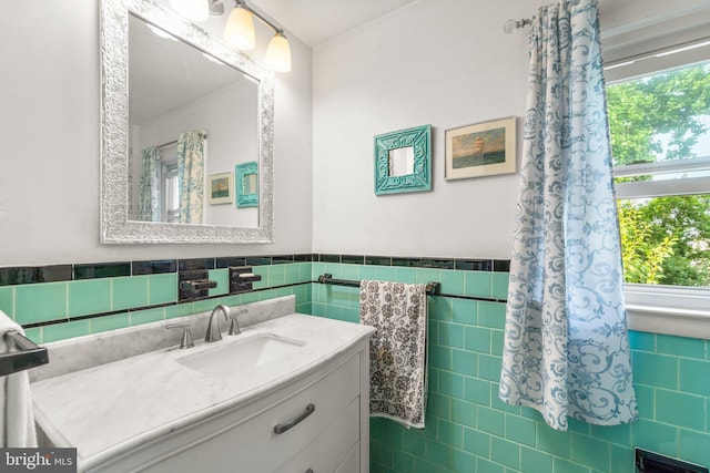 206 Mountain Rd, Linthicum Heights, MD 21090 - bathroom with tile walls, vanity, plenty of natural light, and wainscoting