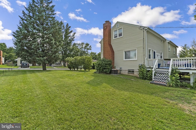 206 Mountain Rd, Linthicum Heights, MD 21090 - view of home's exterior featuring central air condition unit, a deck, a chimney, and a lawn