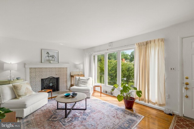 206 Mountain Rd, Linthicum Heights, MD 21090 - living area with a tiled fireplace and wood finished floors