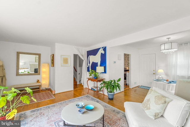 206 Mountain Rd, Linthicum Heights, MD 21090 - living area featuring wood finished floors, stairway, a chandelier, and baseboards