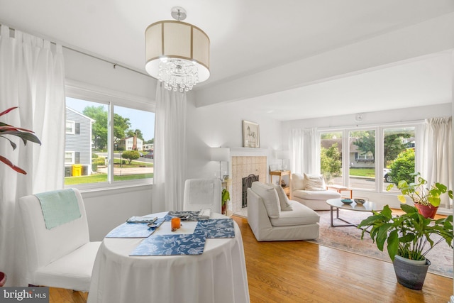 206 Mountain Rd, Linthicum Heights, MD 21090 - dining room with wood finished floors, a fireplace, and a chandelier